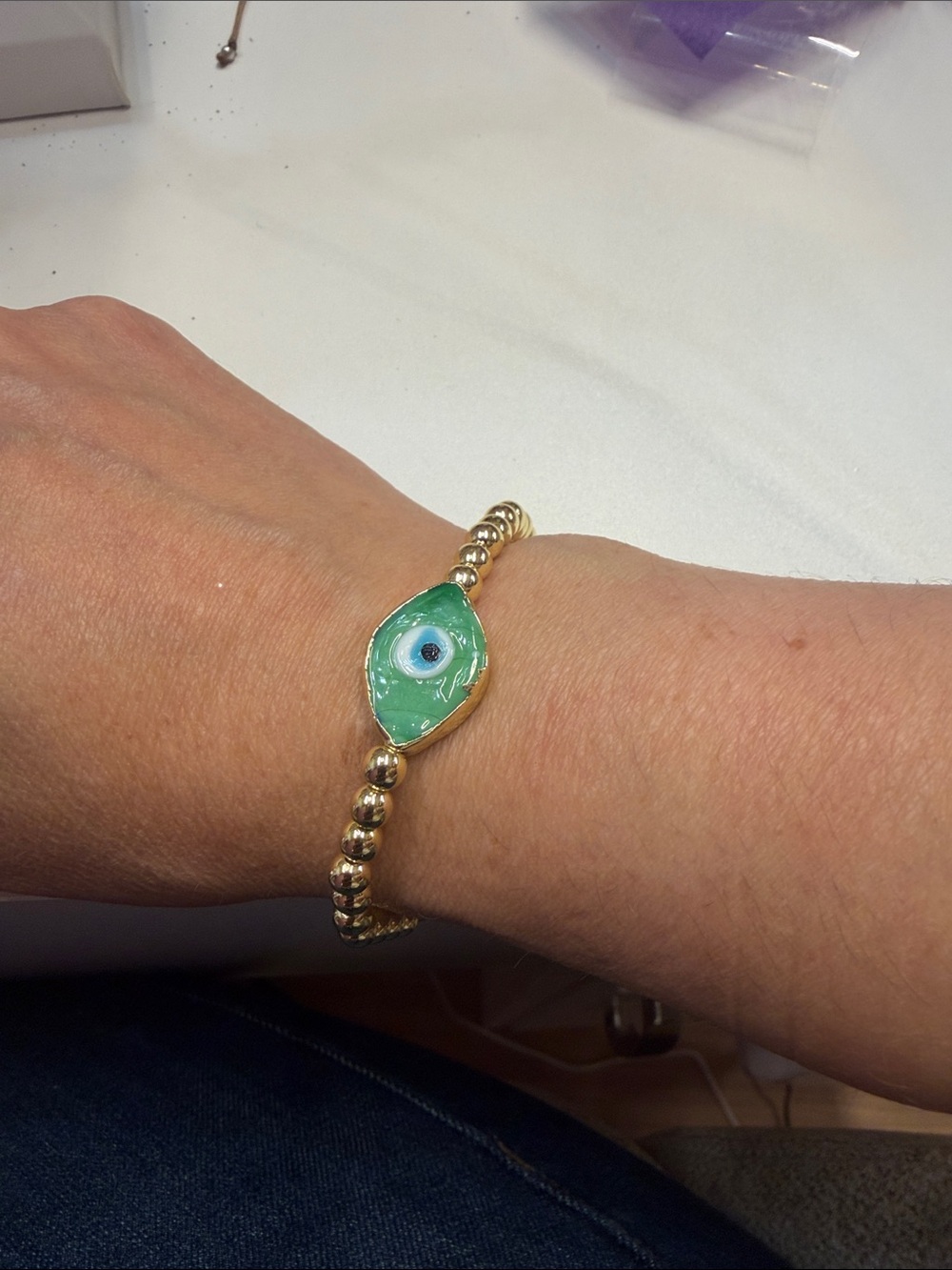 Gold Beaded Bracelet with Green Evil Eye Charm